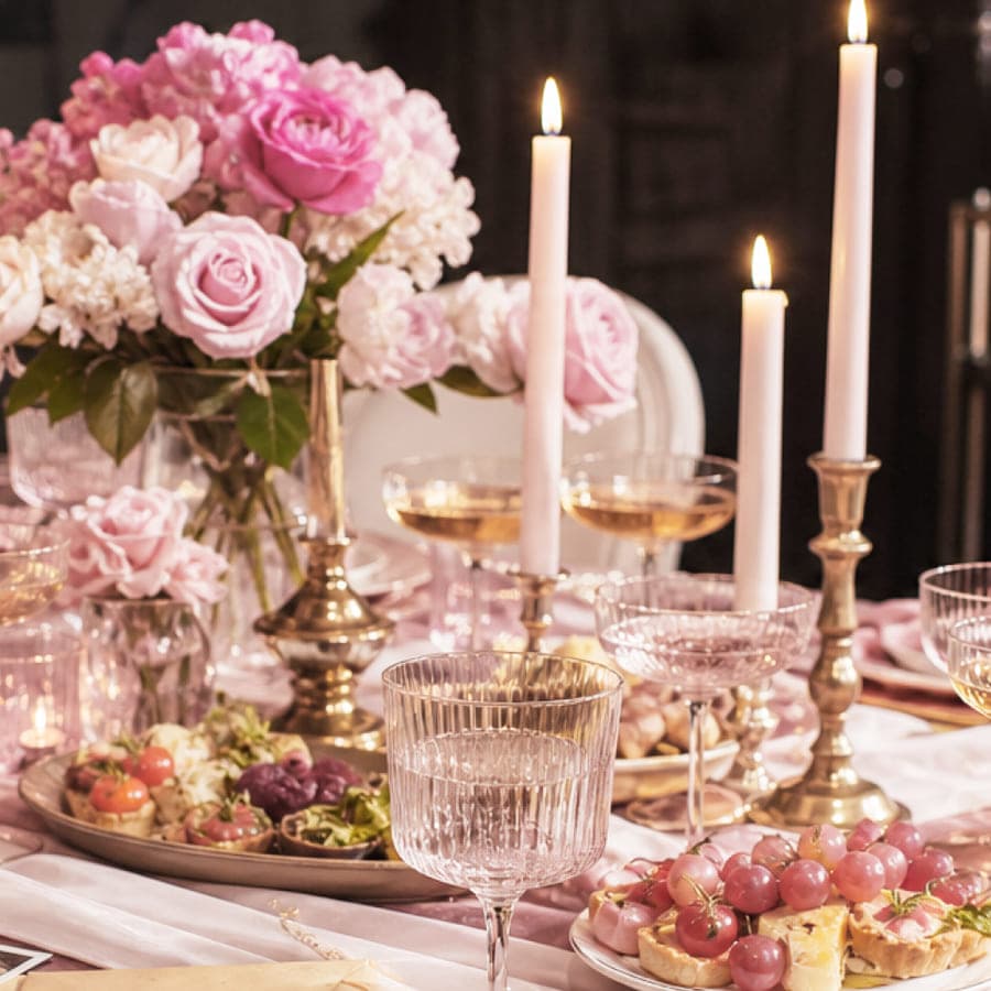 Festive table with roses, candles and finger food