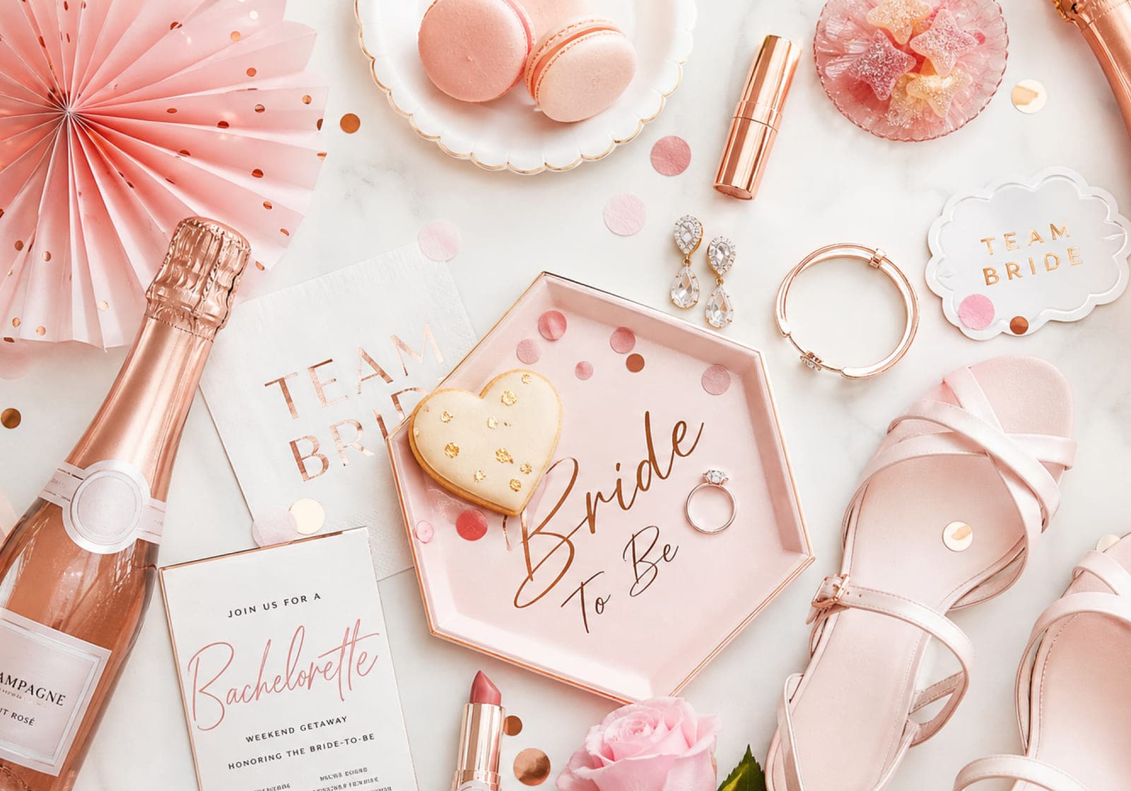 Team Bride decorations, rosé champagne and a hen party invitation